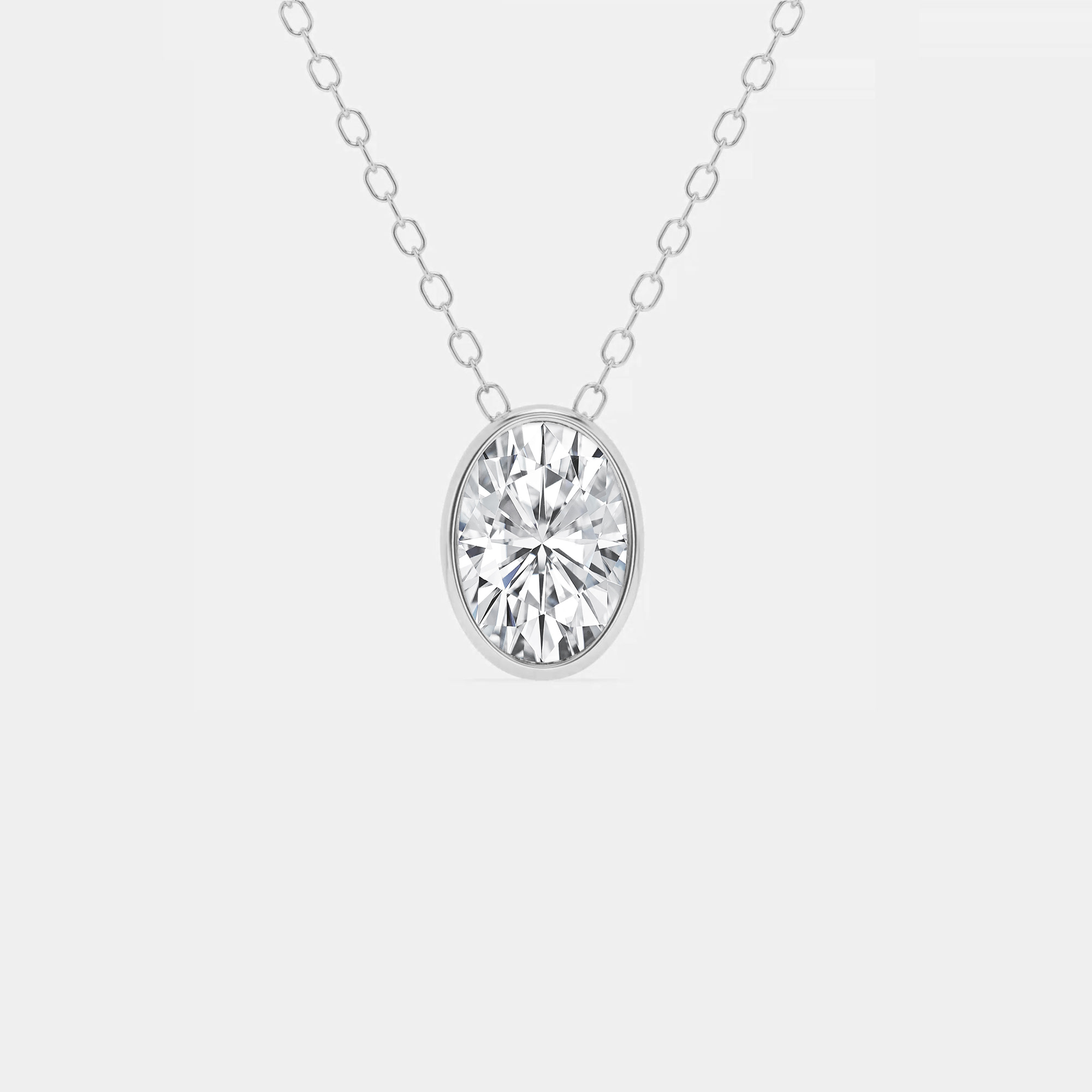 3/4 ct.tw. Oval Diamond East West Bezel Set Solitaire Pendant with Adjustable Chain in 14K Gold